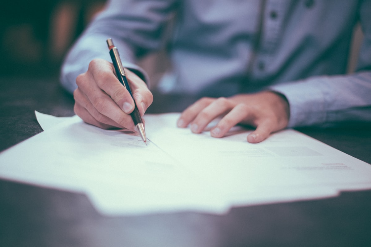 Person reviewing identity documents at a desk